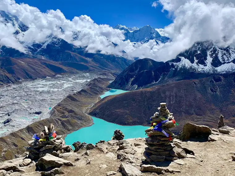 Stone cairns on Gokyo Ri above the turquoise lakes and the glacier