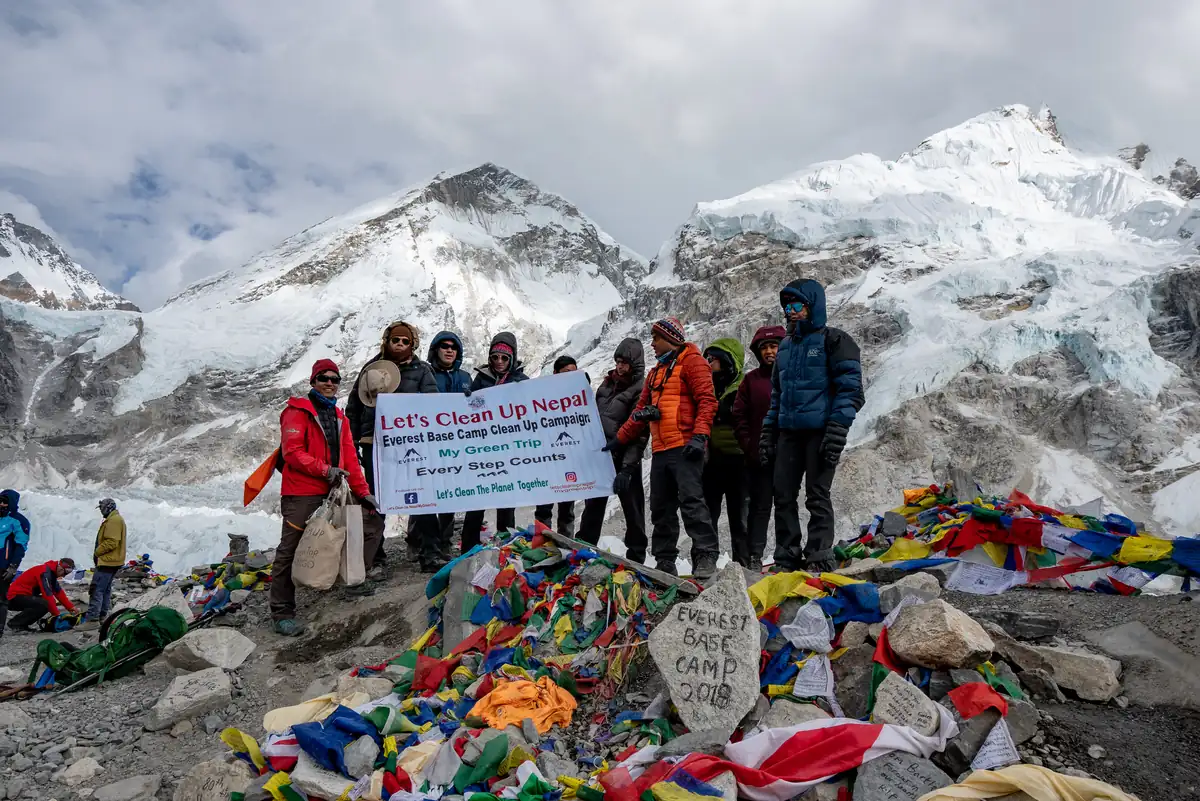 A Let's Clean Up Nepal campaign group with their banner at Everest Base Camp