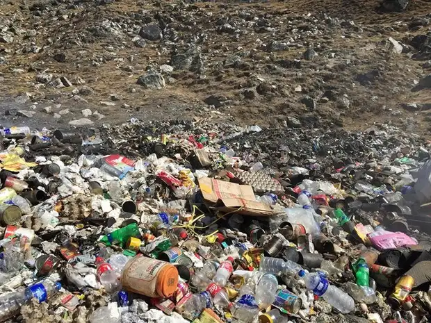 A pile of discarded plastic waste on a trekking route